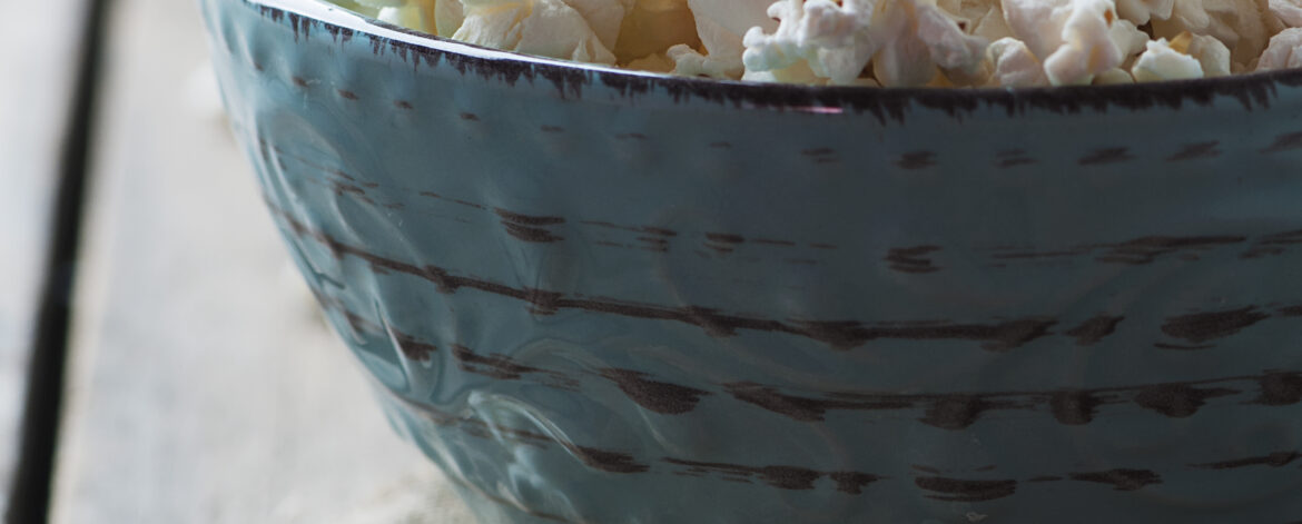 Popcorn and cola on the wooden table