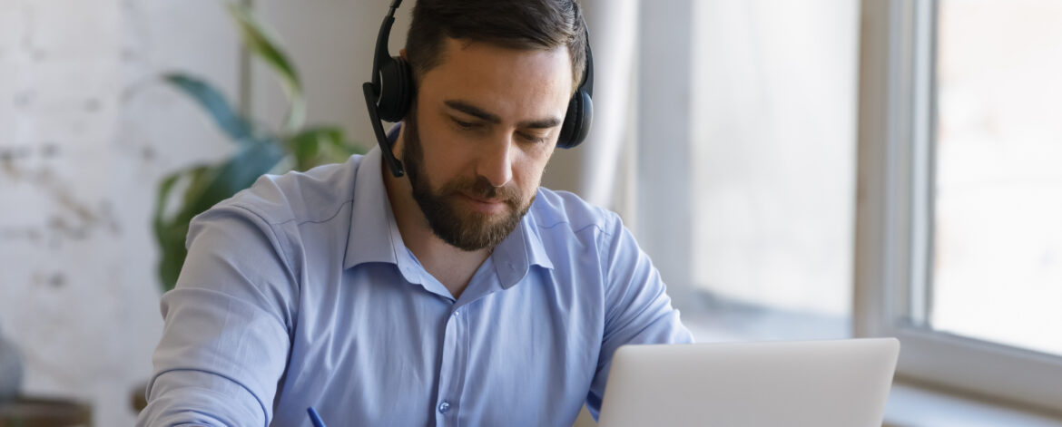 Focused young man studying distantly at home.